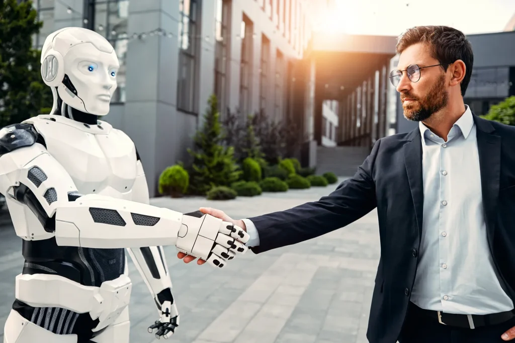 Un ejecutivo estrecha la mano de un robot humanoide frente a un edificio de oficinas